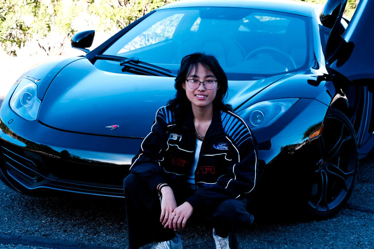 Lydia in front of a car