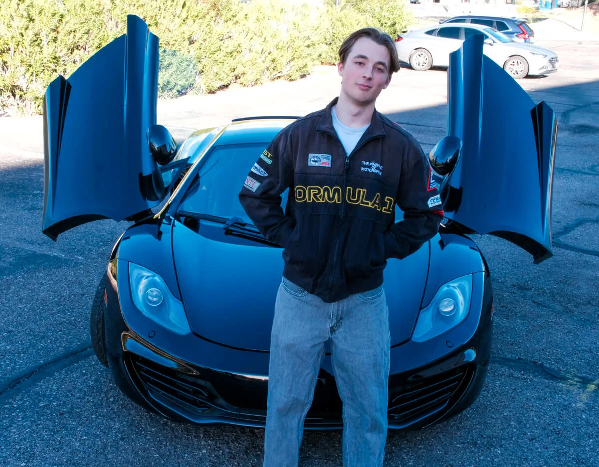 Adam in front of a car