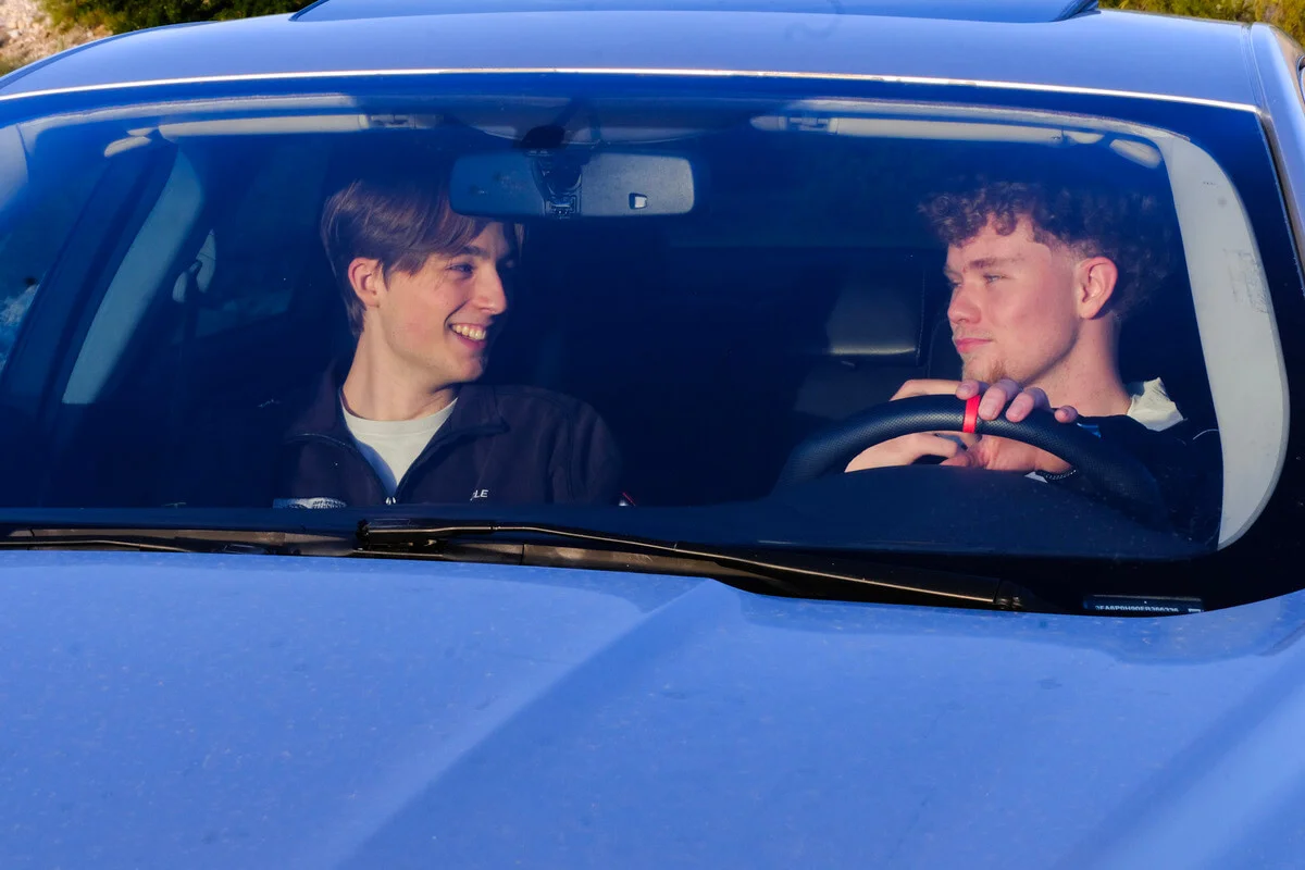 Ross and Adam inside of a car