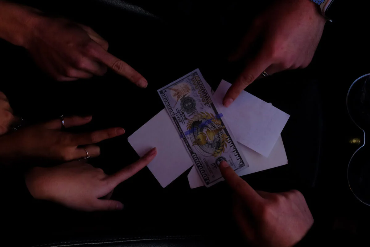 Fingers pointing at money